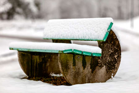 The snow now covers the bench as wellの写真素材