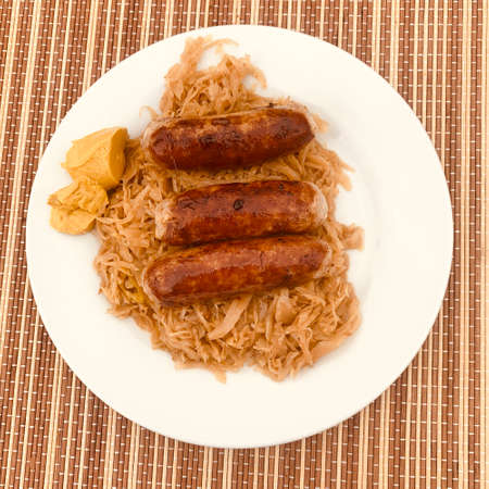 Three sausages with cabbage and mustardの写真素材