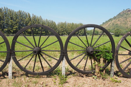 Old wagon wheel for the garden fenceの写真素材