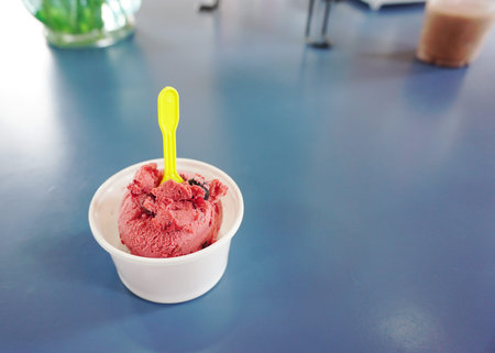 raspberry ice-cream one scoop on the blue table
