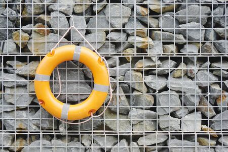 life preserver on the rock wallの写真素材