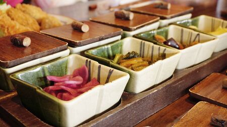 close up of the small bowls of traditional side dish in Japanese culture contain of pickles, pickled vegetablesの写真素材