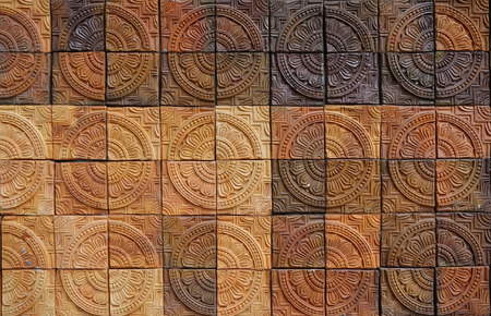 Wall elevation detail of the circle shape decorative orange tone color  terracotta tiles texture with diffence tone colorの写真素材