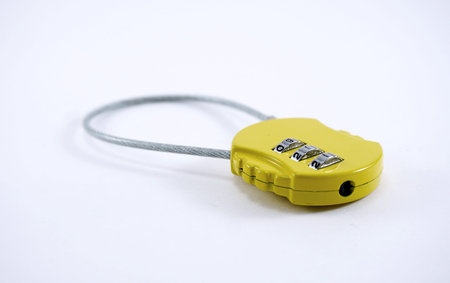 isolated of small yellow baggage numaric lock with 911 number on it
