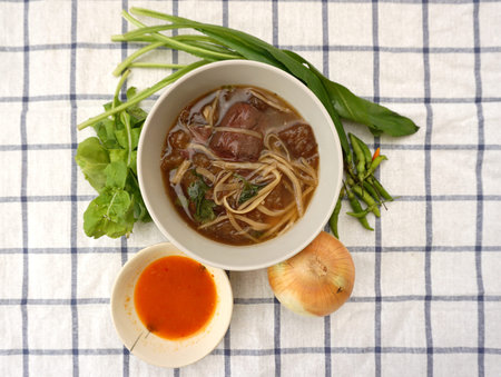 top view of Homemade fish maw soup with chili vinegar sauce and vegetable