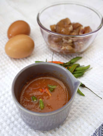 closed up of Food ingredients on the white fabric with a bowl of spicy sauceの写真素材