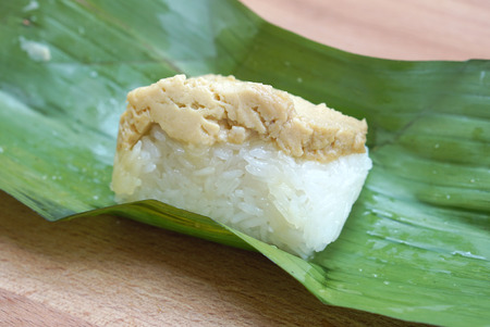 traditional Thai sweetmeat made from sweet sticky rice with egg custard in banana leaves packageの写真素材