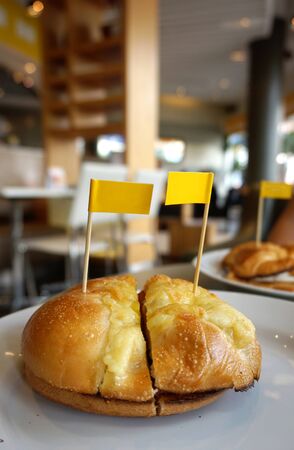 closed up of Bagel with egg and katch up with small yellow flagsの写真素材