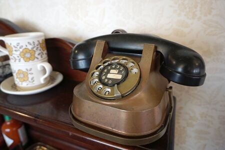 Vintage manual dial telephone in bronze colorの写真素材