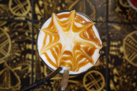 iced caramel macchiato with caramel art and pattern background