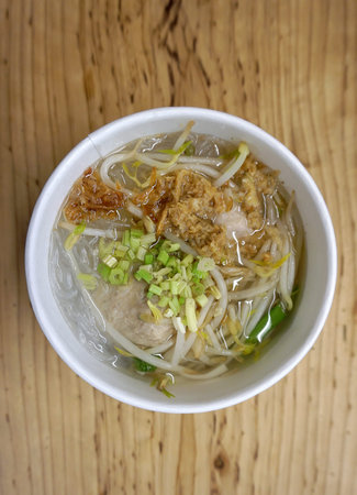 porkball noodle clear soup in the paper cup on the table