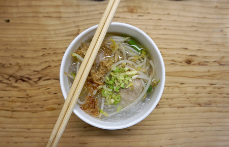 porkball noodle clear soup in the paper cup on the tableの写真素材