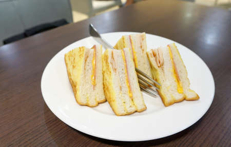 Ham and Cheese sandwiches on white platesの写真素材