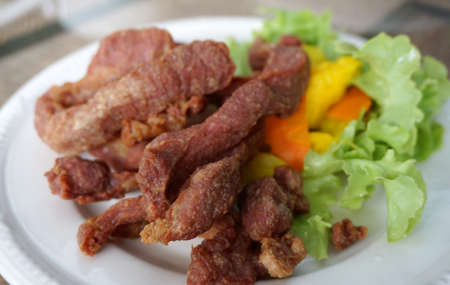 deep fried dried pork serving with fresh vegetableの写真素材