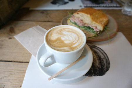 hot coffee latte with sandwiches backgroundの写真素材