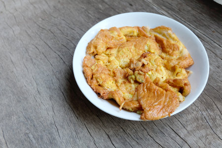 homemade asian omelet with rustic timber background