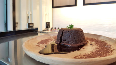 chocolate lava cake on timber plateの写真素材