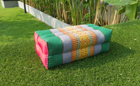 traditional Thai pillow on green grass outdoorの写真素材