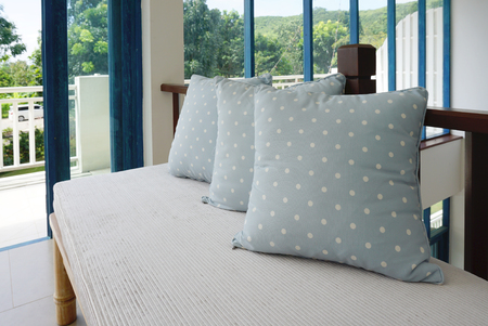 Generic blue pattern pillow isolated on bench indoorの写真素材