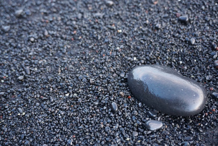 Black shinny rock on the rock beach in Icelandの写真素材
