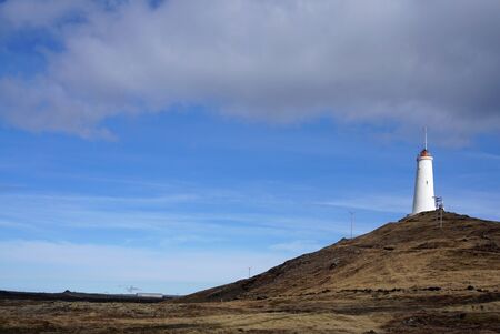 Beautiful Meadow landscape on the road with lighthouse background in Icelandの写真素材