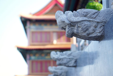 Typical chinese stone dragon head sculpture with chinese ornament detail in the temple in Thailandのeditorial素材