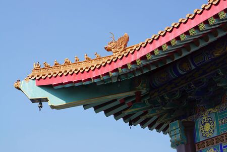 Typical chinese style roof top with chinese ornament detail in the temple in Thailandのeditorial素材