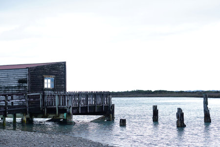 rustic timber facade house on the lake side with lake backgroundの写真素材