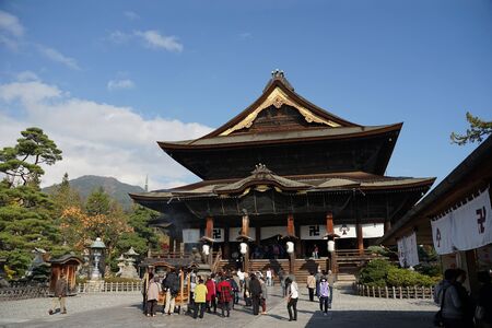 Nagano, Japan- 5 November,2018 : People walking and taking a photo of the Landmark of Nagano city , Zenko-ji temple with beautiful heritage architecture on the sunny day on 5 November,2018 in Nagano, Japanのeditorial素材