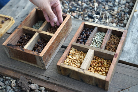 Close up of dried coffee beans in the wooden boxes on timber floor