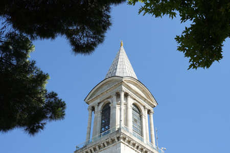 Istanbul, Turkey - 26 July, 2019 : Beautiful clock tower in the TopkapÄ± Palace surrounding with plants and garden with blue sky background on 26 July, 2019 in Istanbul, Turkeyのeditorial素材