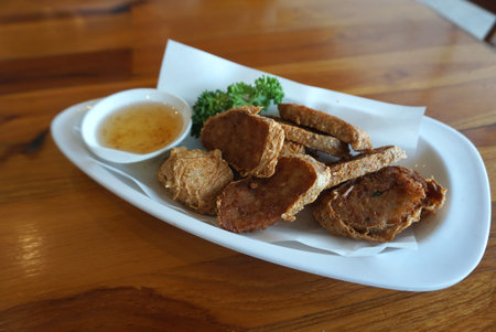 Deep fried shrimp-rolled with  sweet and sour plum sauce on white plate