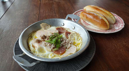 Pan-fried egg with Vietnamese Pork Sausage and mince pork toppings in North eastern of Thailand styleの写真素材
