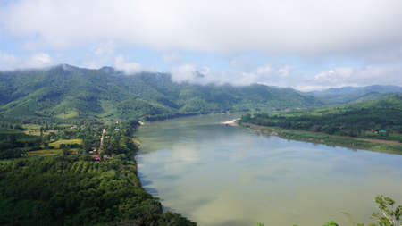 Green Mountain range and Khlong river at the border of Laos from the view point of Chaing Kkhan skywalk, Loei Province , Thailandの写真素材