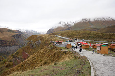 Ganisi , Georgia â 15 October,2021 : The Russia Georgia friendship monument at Gudari view point in autumn with the Caucasus mountain range background â 15 October,2022 in Ganisi , Georgiaのeditorial素材