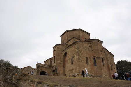 Mtskheta, Georgia â 15 October,2021 : Tourist walking around the old building of  Jvari Monastery with light rain â 15 October,2022 in Mtskheta, Georgiaのeditorial素材