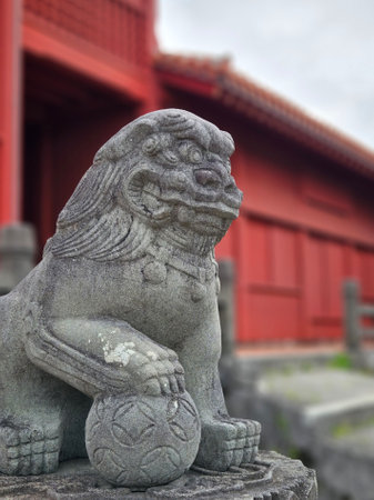 Close up of traditional Shisa lion dog sculpture of Okinawa island decoration on the fence of the house of temple in Okinawa, Japanの写真素材