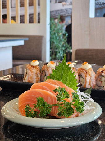 Close up of Salmon sashimi Japanese style food serving coriander and Daikon radish.の写真素材
