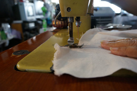 Old sewing machine is sewing cloth