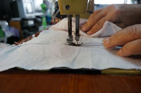 Sewing on the old sewing machineの写真素材