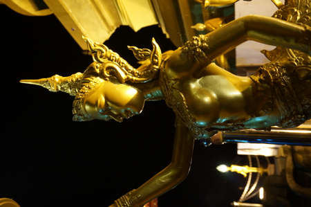 Side of golden goddess at nightの写真素材