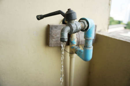 Chrome faucet and water pipeline with blue pvc pipe.の写真素材