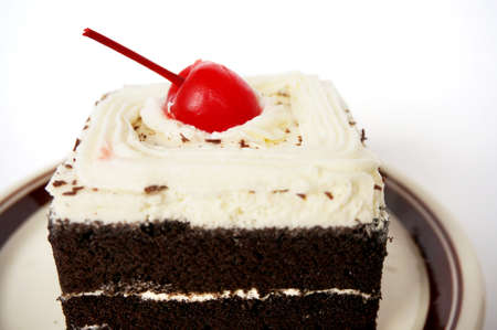 Colorful chocolate black forest cake decorated with cherry isolated on white background, close upの写真素材