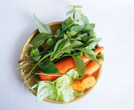 Vegatables set - diet food for health - green sweet basil ( Thai basil ), white cabbages and orange carrots isolated on white backgroundの写真素材