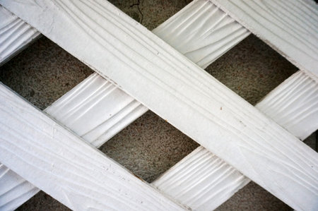 Vintage image of white wood lath on cement wall texture and background, close up