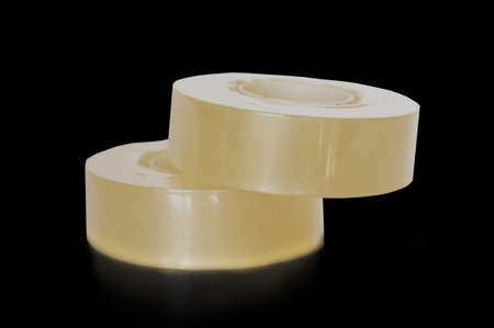 Transparent adhesive tapes isolated on black backgroundの写真素材