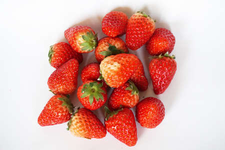 Close up of photo of very fresh havested group of red strawberries isolated on white backgroundの写真素材