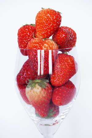 Close up of photo of very fresh havested red strawberries in champagne glass isolated on white backgroundの写真素材