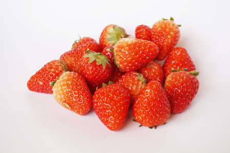Close up of photo of very fresh havested group of red strawberries isolate on white backgroundの写真素材