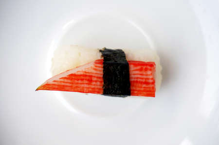 Asia - Asian eating food, Japanese food, roll crab stick and seaweed sushi on white plate isolated on white background.の写真素材
